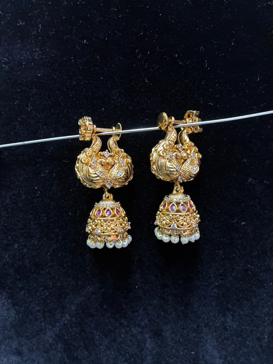 Makarakundanalu feature a detailed peacock design adorned with white stones