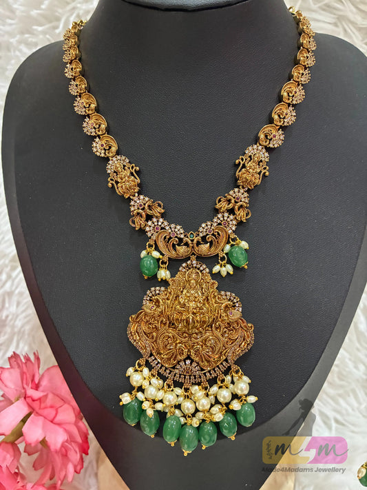 Gold-plated temple style necklace with a Goddess Lakshmi pendant and matching earrings with green beads Made4Madams