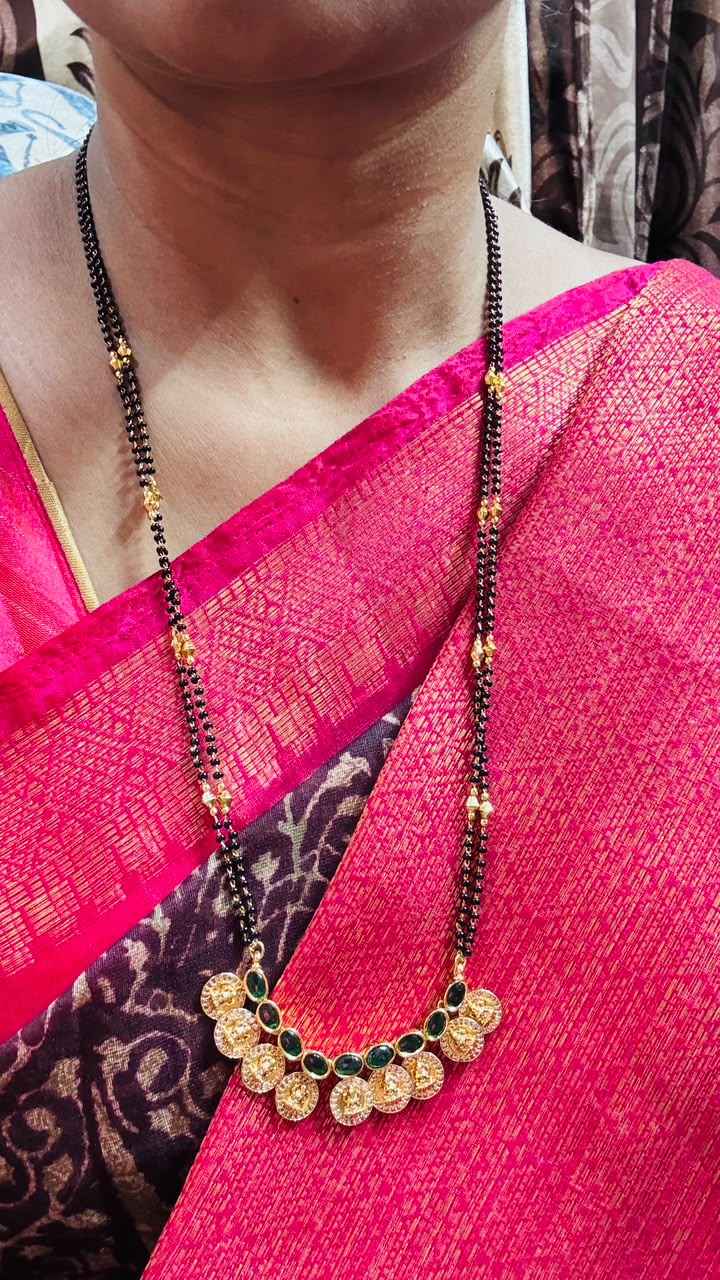 Traditional double-string black bead mangalsutra featuring a Lakshmi kasu pendant