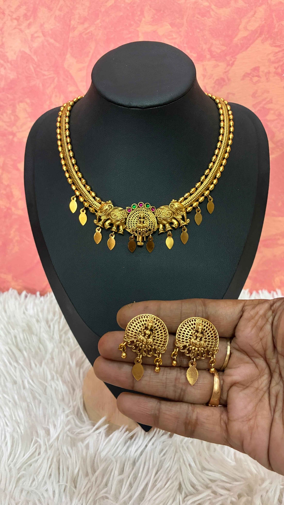 Antique gold-finish temple necklace highlighted by a central Goddess Lakshmi motif