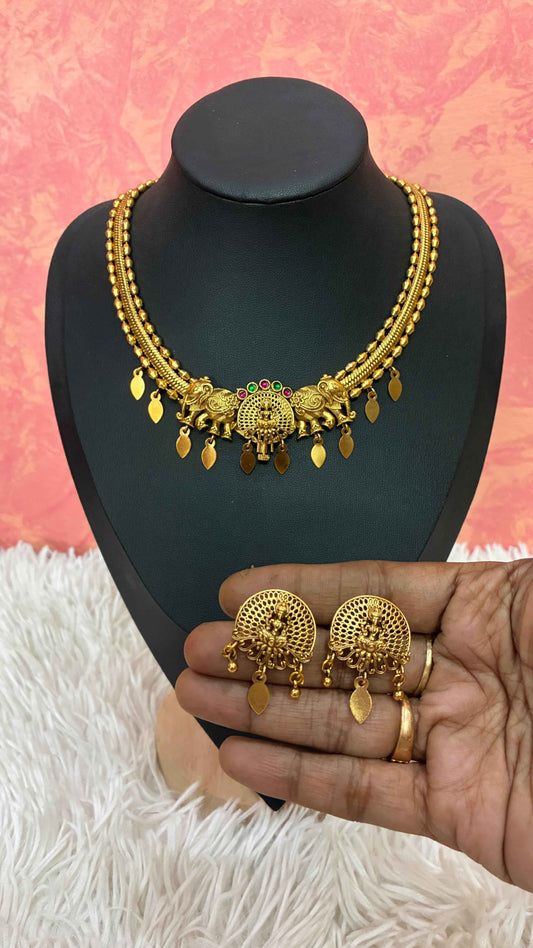 Antique gold-finish temple necklace highlighted by a central Goddess Lakshmi motif