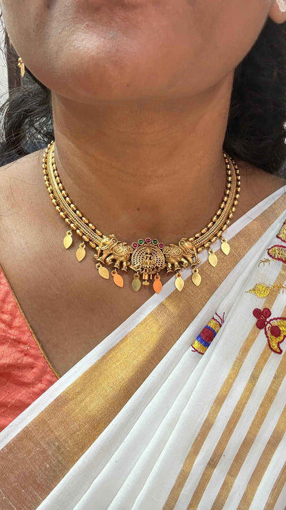 Antique gold-finish temple necklace highlighted by a central Goddess Lakshmi motif