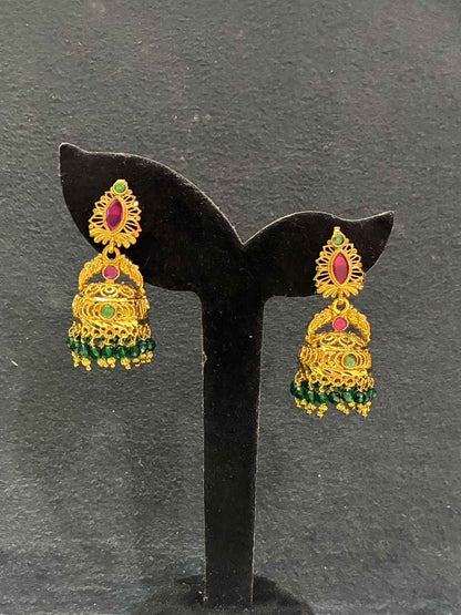 Gold-plated jhumka earrings feature red and green stone detailing