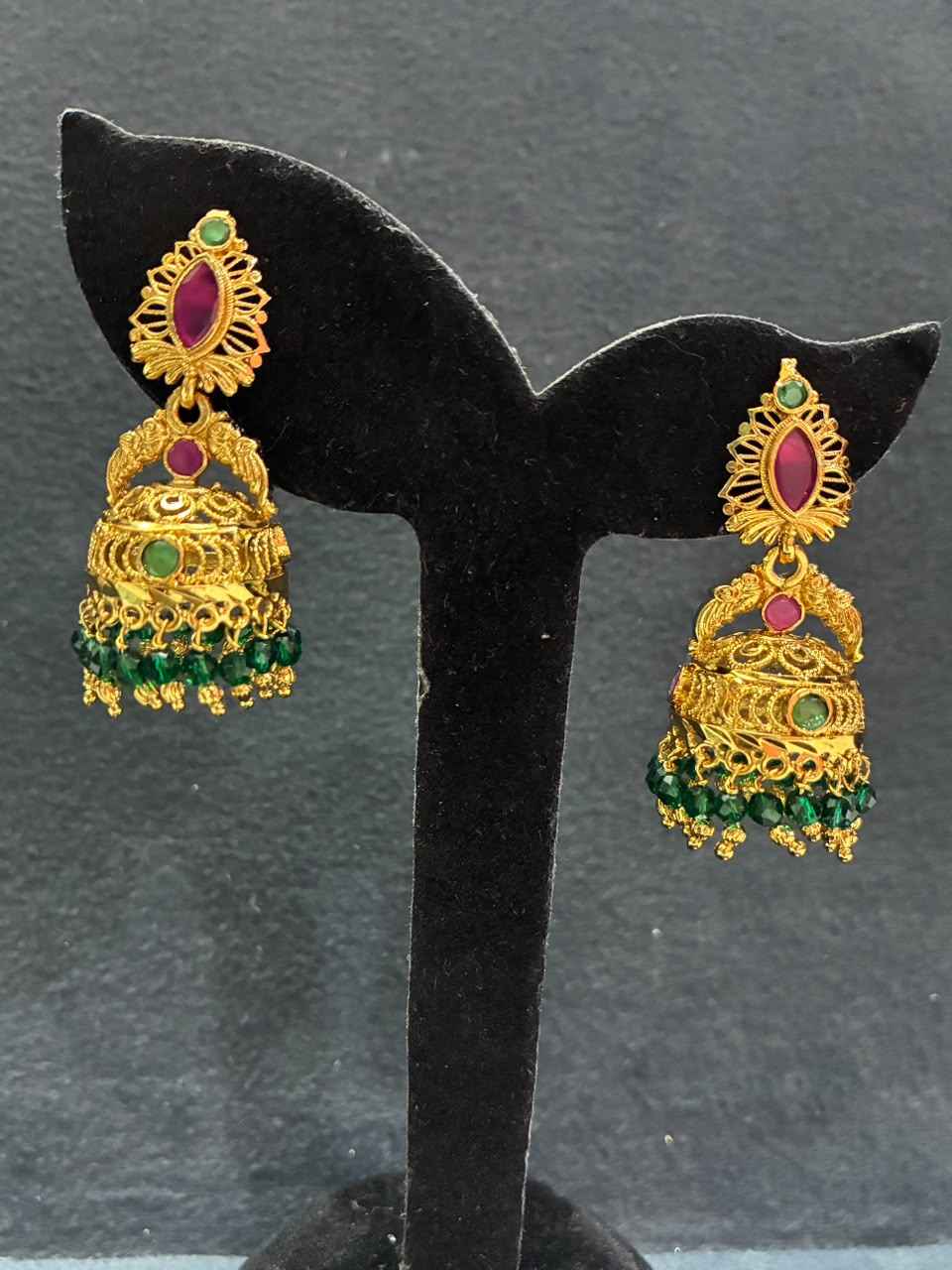 Gold-plated jhumka earrings feature red and green stone detailing