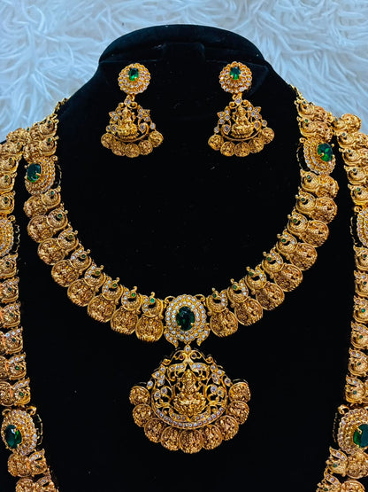 Bridal temple jewelry set features Lakshmi coin motifs and emerald stone
