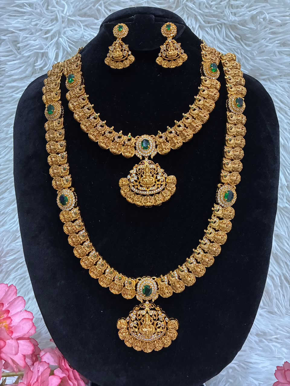 Bridal temple jewelry set features Lakshmi coin motifs and emerald stone