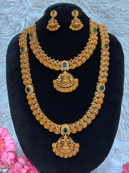 Bridal temple jewelry set features Lakshmi coin motifs and emerald stone