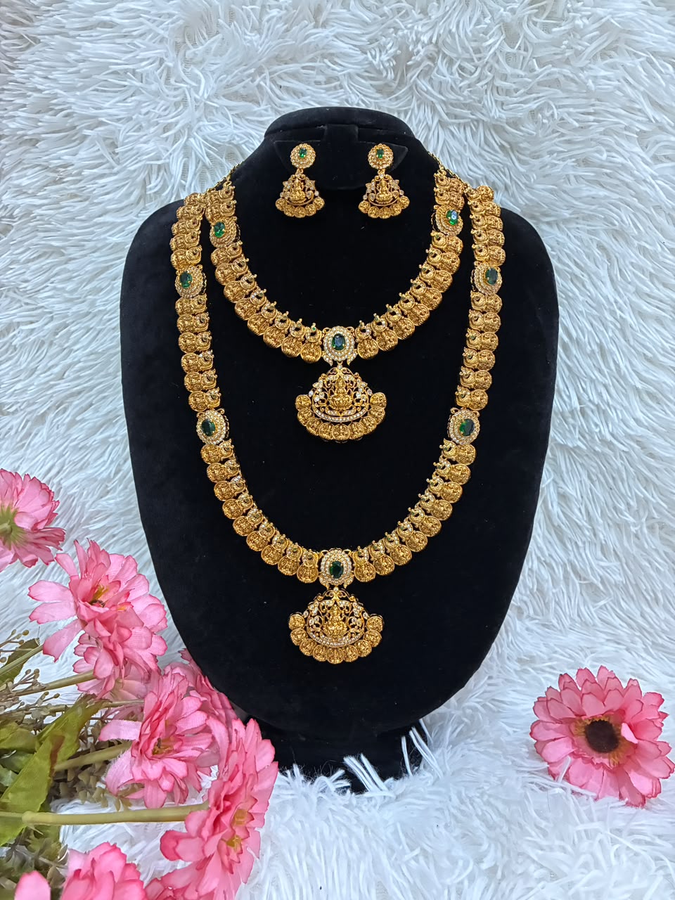 Bridal temple jewelry set features Lakshmi coin motifs and emerald stone