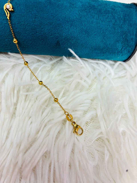 18K gold-plated stainless steel bracelet features a tiny CZ stone station.
