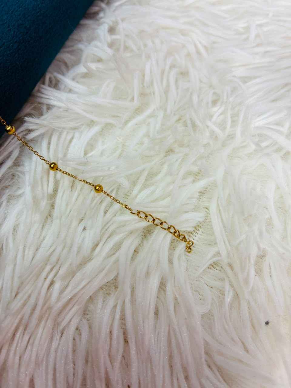 18K gold-plated stainless steel bracelet features a tiny CZ stone station.