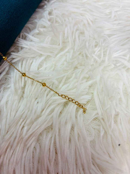 18K gold-plated stainless steel bracelet features a tiny CZ stone station.