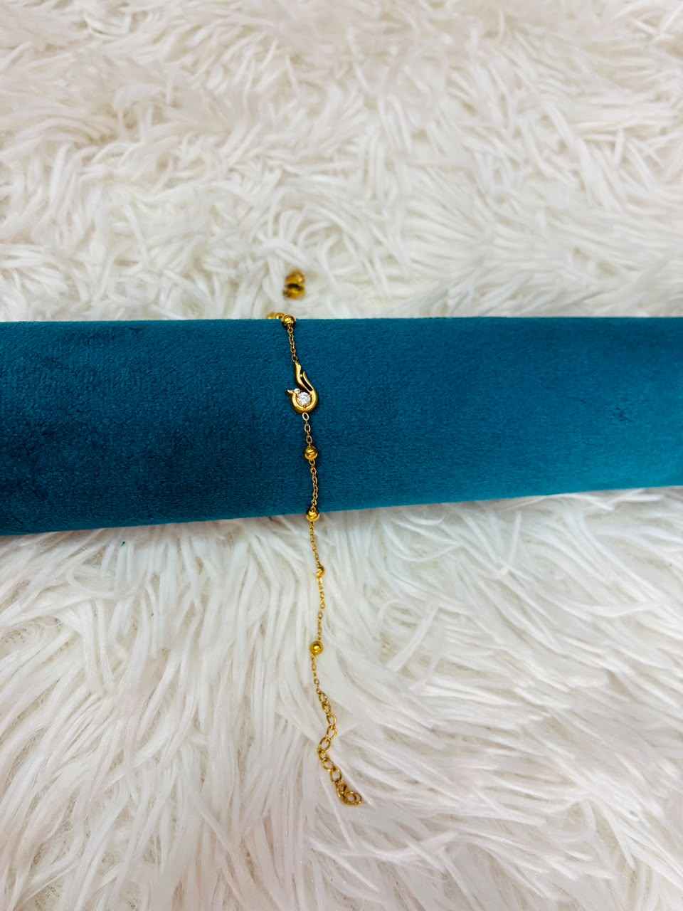 18K gold-plated stainless steel bracelet features a tiny CZ stone station.