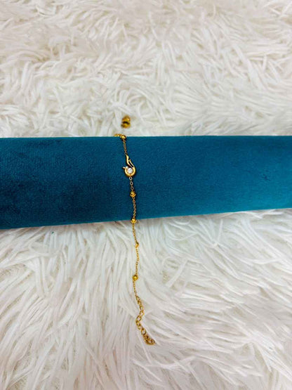 18K gold-plated stainless steel bracelet features a tiny CZ stone station.