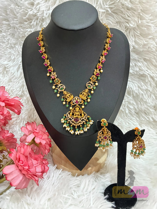 Gold-plated temple Design necklace and earrings set featuring a Lakshmi pendant and CZ stones in multi-color. Made4Madams