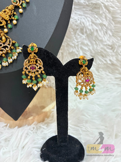 Gold-plated temple Design necklace and earrings set featuring a Lakshmi pendant and CZ stones in multi-color. Made4Madams