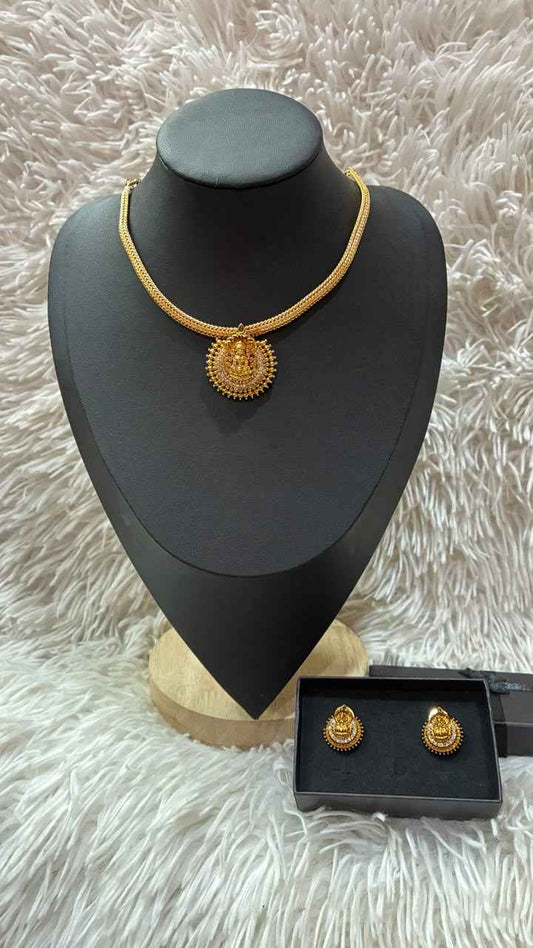Lakshmi nanu necklace set features a traditional gold-plated design