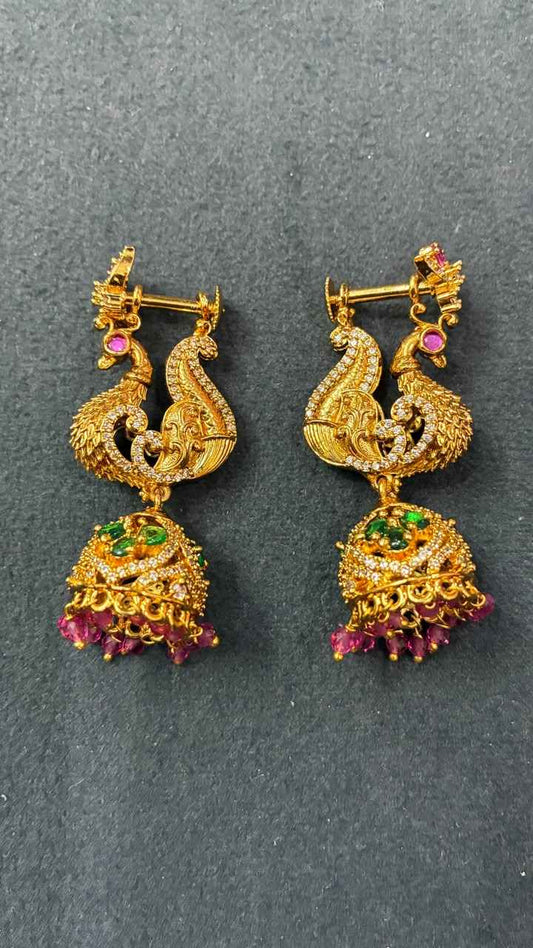 Makarakundanalu feature a detailed peacock design with Pink beads