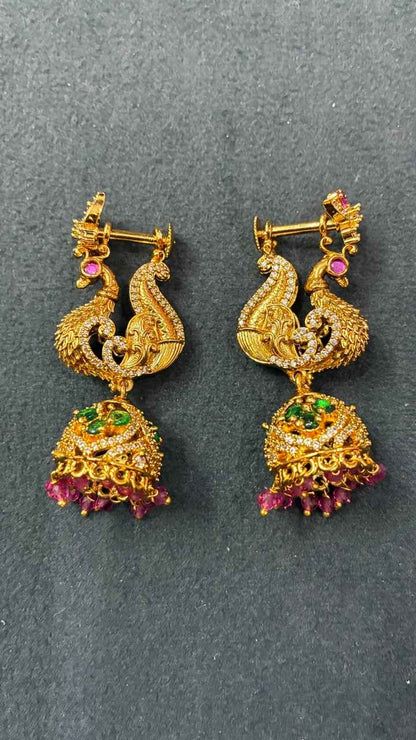 Makarakundanalu feature a detailed peacock design with Pink beads
