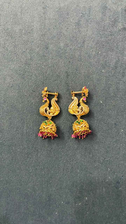 Makarakundanalu feature a detailed peacock design with Pink beads