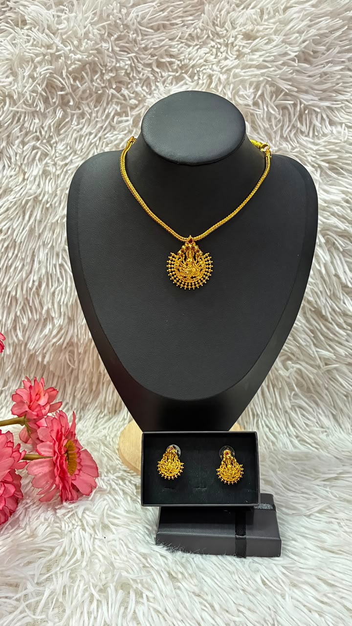 Lakshmi nanu necklace set features a traditional gold-plated design