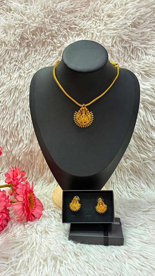 Lakshmi nanu necklace set features a traditional gold-plated design