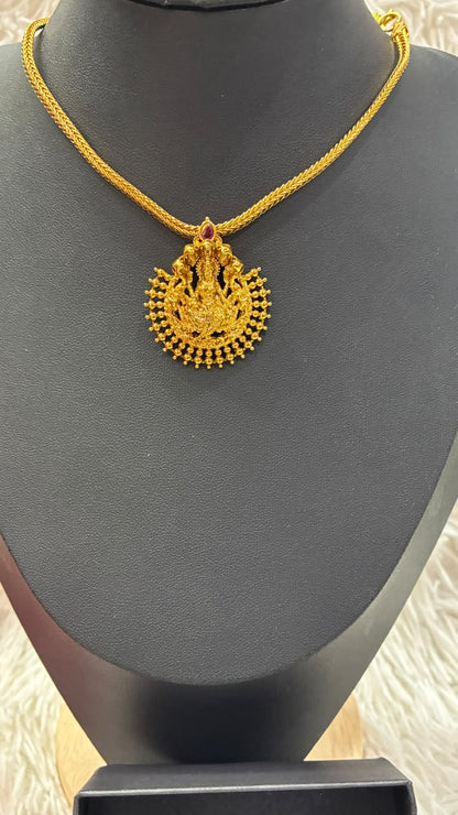 Lakshmi nanu necklace set features a traditional gold-plated design