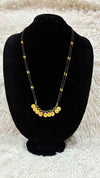 Traditional double-string black bead mangalsutra featuring a Lakshmi kasu pendant