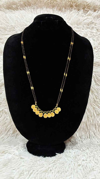 Traditional double-string black bead mangalsutra featuring a Lakshmi kasu pendant
