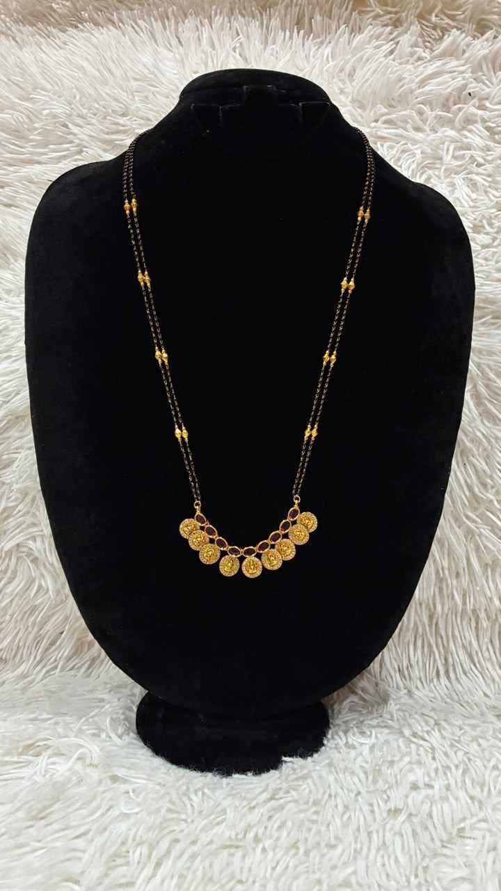 Traditional double-string black bead mangalsutra featuring a Lakshmi kasu pendant