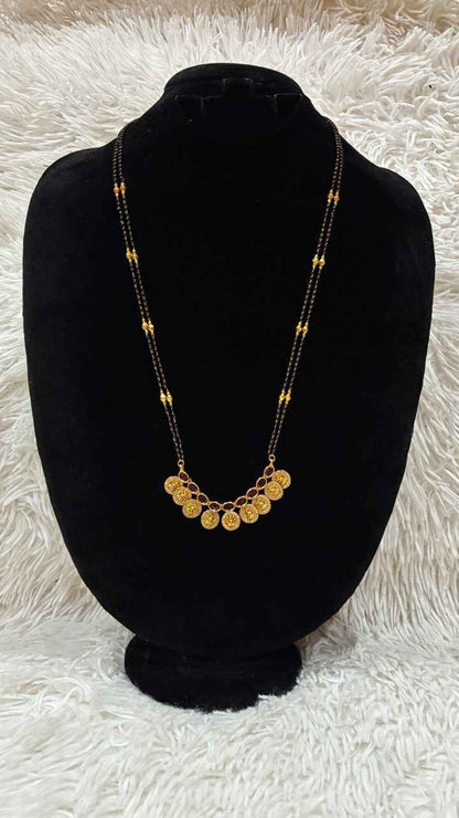 Traditional double-string black bead mangalsutra featuring a Lakshmi kasu pendant