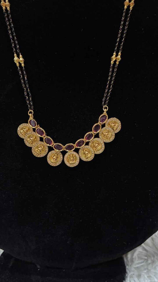 Traditional double-string black bead mangalsutra featuring a Lakshmi kasu pendant