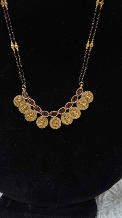 Traditional double-string black bead mangalsutra featuring a Lakshmi kasu pendant