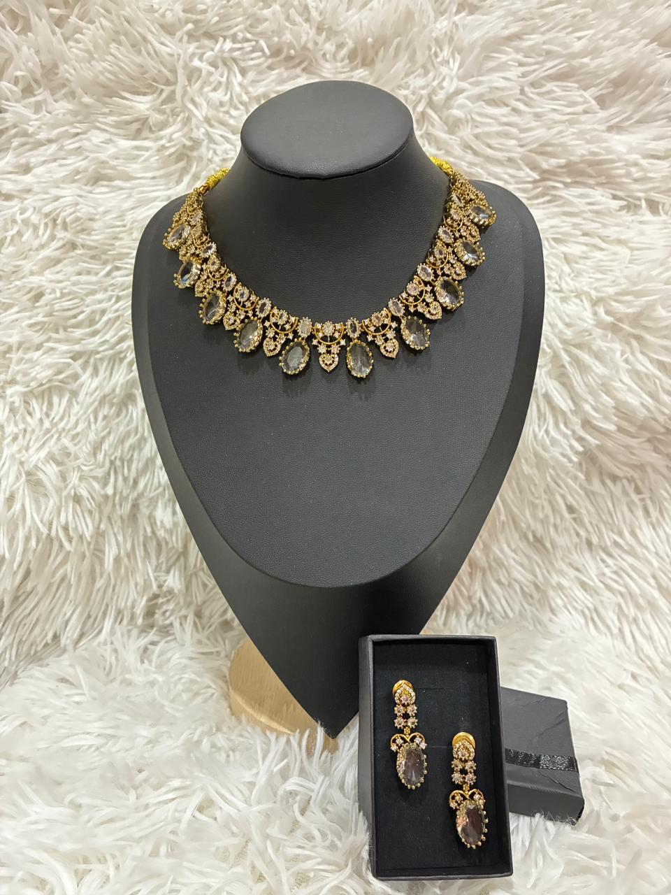 AD stoned necklace set in a gold tone