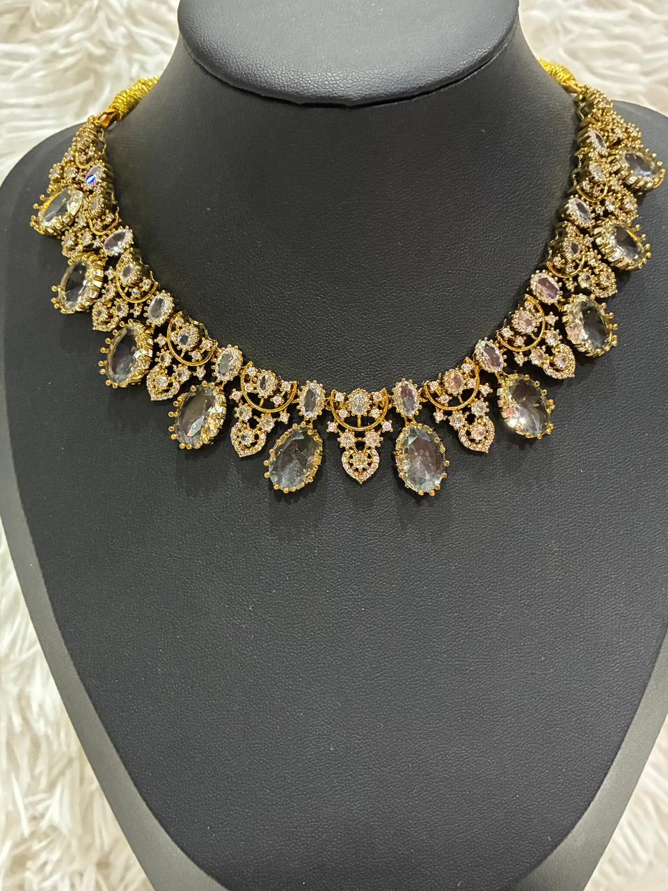 AD stoned necklace set in a gold tone