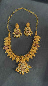 Temple necklace features intricate Lakshmi motifs, emerald stones