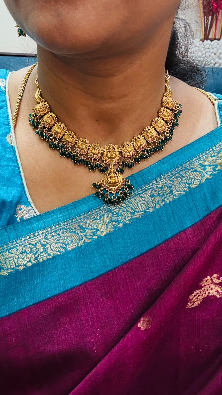 Antique-style Lakshmi necklace features intricate gold temple motifs
