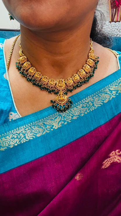 Antique-style Lakshmi necklace features intricate gold temple motifs