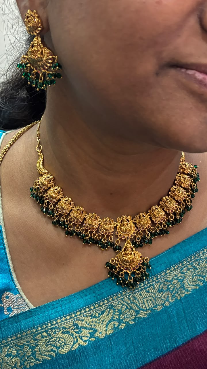 Antique-style Lakshmi necklace features intricate gold temple motifs