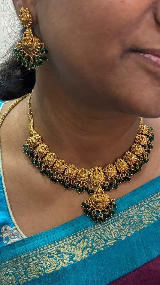 Antique-style Lakshmi necklace features intricate gold temple motifs